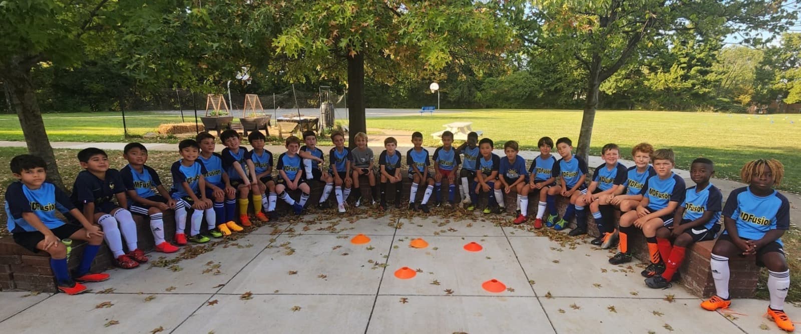 MD Fusion players from multiple teams gathered in a circle at a camp session